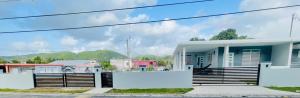 a house with a fence in front of it at Home for your stay in Humacao