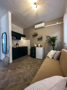 a living room with a couch and a kitchen at Apartments Dent in Umag