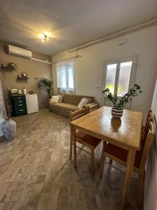 a living room with a table and a couch at Apartments Dent in Umag