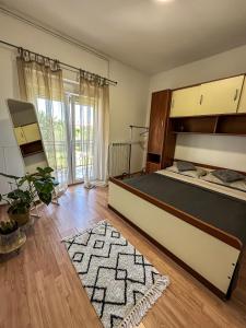 a bedroom with a large bed and a wooden floor at Apartments Dent in Umag