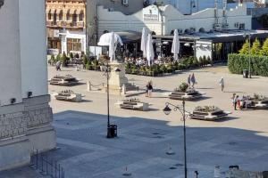 a city street with people walking around in a plaza at MaraM in Constanţa