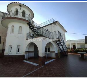 a building with a spiral staircase on the side of it at Casa La Torre de la Balsa de Cela 