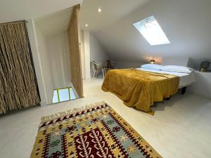 a bedroom with a bed and a rug on the floor at Design apartment with garage in Santander