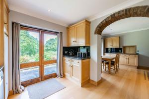 a kitchen with a table and a large window at Millwood in Horstead