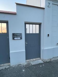 a blue building with a door and a sign on it at Dream Apartman in Levél