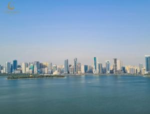 a view of a city from the water at Corniche Hotel Sharjah in Sharjah