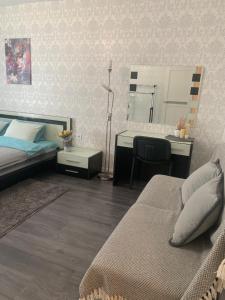 a bedroom with two beds and a desk and a mirror at Квартал in Khmelnytskyi