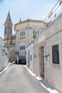an empty street with a building and a church at Trullo Dimora Zaccaria in Alberobello