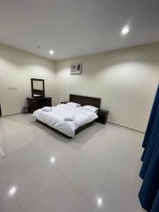 Ліжко або ліжка в номері قصر الجادل للشقق الفندقية