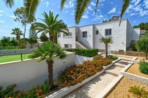 a house with palm trees in front of it at Mercedes in Jávea