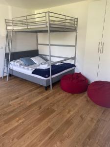 two bunk beds in a room with a wooden floor at Studio apartment Ta5ek in Jesenice