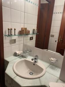 a bathroom with a sink and a mirror at La Valle B&B in Brescia