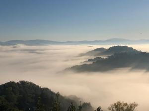 una vista de un valle nublado con montañas en el fondo en Residenza il Punto en Perugia