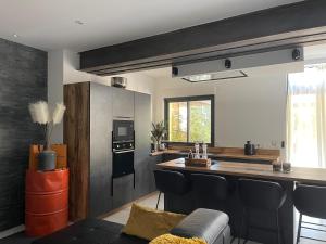 a kitchen with a counter and a kitchen island with chairs at Ibanova Appartements in Collioure