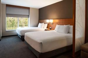 a hotel room with two beds and a window at Hyatt Place Houston/The Woodlands in The Woodlands