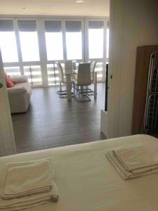 a room with a bed and a table and chairs at PRIMERA LÍNEA DE PLAYA, LA ARENA A TUS PIES in Aguadulce