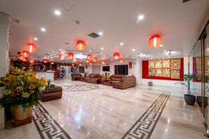 a large living room with couches and chairs and lights at HOTEL ANAND INTERNATIONAL in Bodh Gaya