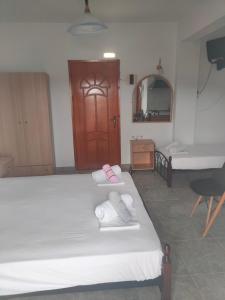 a bedroom with two beds and a sink and a mirror at Vigla House in Sykia Chalkidikis