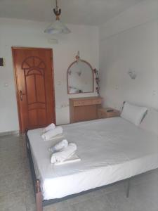 a bedroom with a bed with towels on it at Vigla House in Sykia Chalkidikis