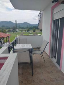 a patio with a table and a chair on a balcony at Vigla House in Sykia Chalkidikis