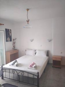 a bedroom with a bed with two towels on it at Vigla House in Sykia Chalkidikis +37 photos