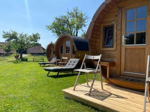 a group of chairs sitting outside of a cabin at Andrella Auszeithof - Schlaferlebnis im Holzfass in Friedersbach