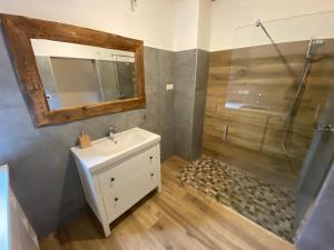 y baño con lavabo y ducha. en Andrella Auszeithof - Schlaferlebnis im Holzfass en Friedersbach