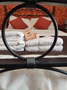 a room with a bed with towels on it at Château Saint-Martin in Carcassonne