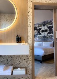 a bedroom with two beds and a mirror at CONTI HOTEL VILNIUS, Conference Centre, Restaurant & Bar in Vilnius