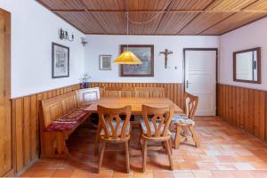 a dining room with a wooden table and chairs at Šentjane bay view house in Portorož