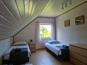 a bedroom with two beds and a window at Lubiatowo Źródlana 10 in Lubiatowo
