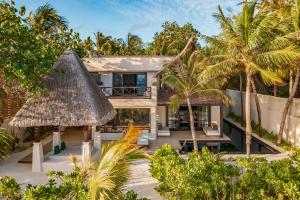 an aerial view of a house with palm trees at OZEN RESERVE BOLIFUSHI - Luxury All Inclusive in Male City