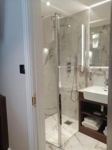 a bathroom with a shower and a sink at The Tudor Hotel in Harrow