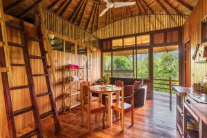 a room with a table and chairs and a ceiling at Paradiselodge Jungleguesthouse in Platanillo