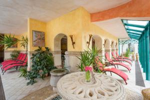 a room with red chairs and a table at Berghotel Ronach in Königsleiten +102 photos