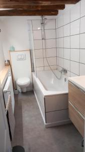 La salle de bains est pourvue de toilettes, d'une baignoire et d'un lavabo. dans l'établissement Gîte Le Courtil, à Bouillon