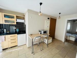 a kitchen with a table and chairs in a room at KazanciApart15 in Istanbul