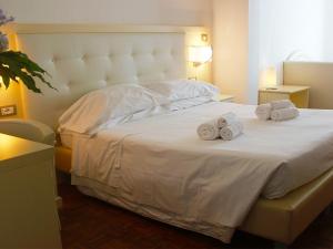 Säng eller sängar i ett rum på Hotel Rio Sanremo