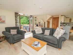 a living room with two couches and a coffee table at Gelli Barn in Llandeilo