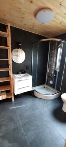 a bathroom with a shower and a sink and a mirror at Na Spokojnej Rodzinne Wakacje in Pogorzelica +58 photos