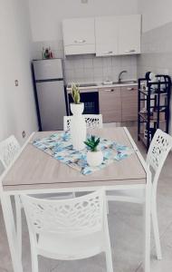 a white table and chairs in a kitchen at Lovin Puglia Vacation in Bari