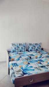 a bed with a blue comforter and pillows at Lovin Puglia Vacation in Bari