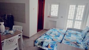 a bedroom with a bed and a table and chairs at Lovin Puglia Vacation in Bari