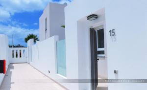 a white building with a door on the side at Royal Dream Villas in Adeje