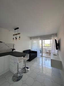 a kitchen and living room with a table and a couch at Studio Antibes Port Vauban. in Antibes