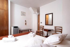a bedroom with a bed and a table and chairs at Harbor Central Place in Hvar