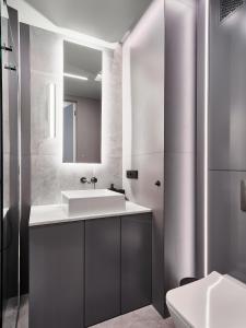 a bathroom with a sink and a mirror at Apartament Natura D33 Porto Łeba in Łeba