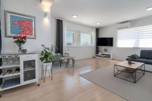 a living room with a couch and a table at Beachfront Apartment with parking in Slatine