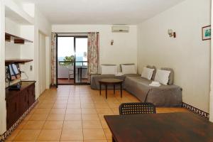 a living room with a couch and a table at Cheerfulway Ouravista Apartamentos in Albufeira
