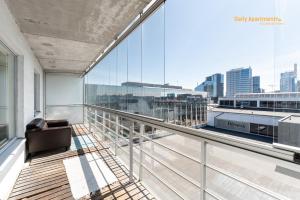 a balcony with a chair and a large window at Daily Apartments - Viru Keskus in Tallinn